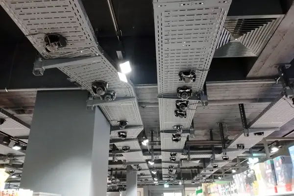 Elektrotechnik im Einzelhandel mit Kabeltrassen, Deckeninstallationen und technischen Komponenten über einer Verkaufsfläche.